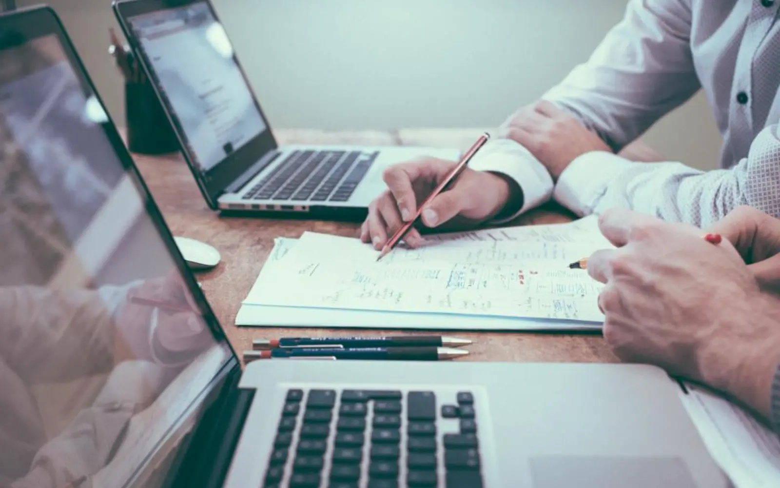 Solicitors reviewing documents at a laptop, the kind of client a law firm website design should speak to